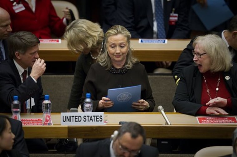 U.S. Secretary of State Hillary Rodham Clinton, center, reacts after delivering a policy statement to the Biological Weapons Convention Review at the United Nations in Geneva, Switzerland, Wednesday, Dec. 7.